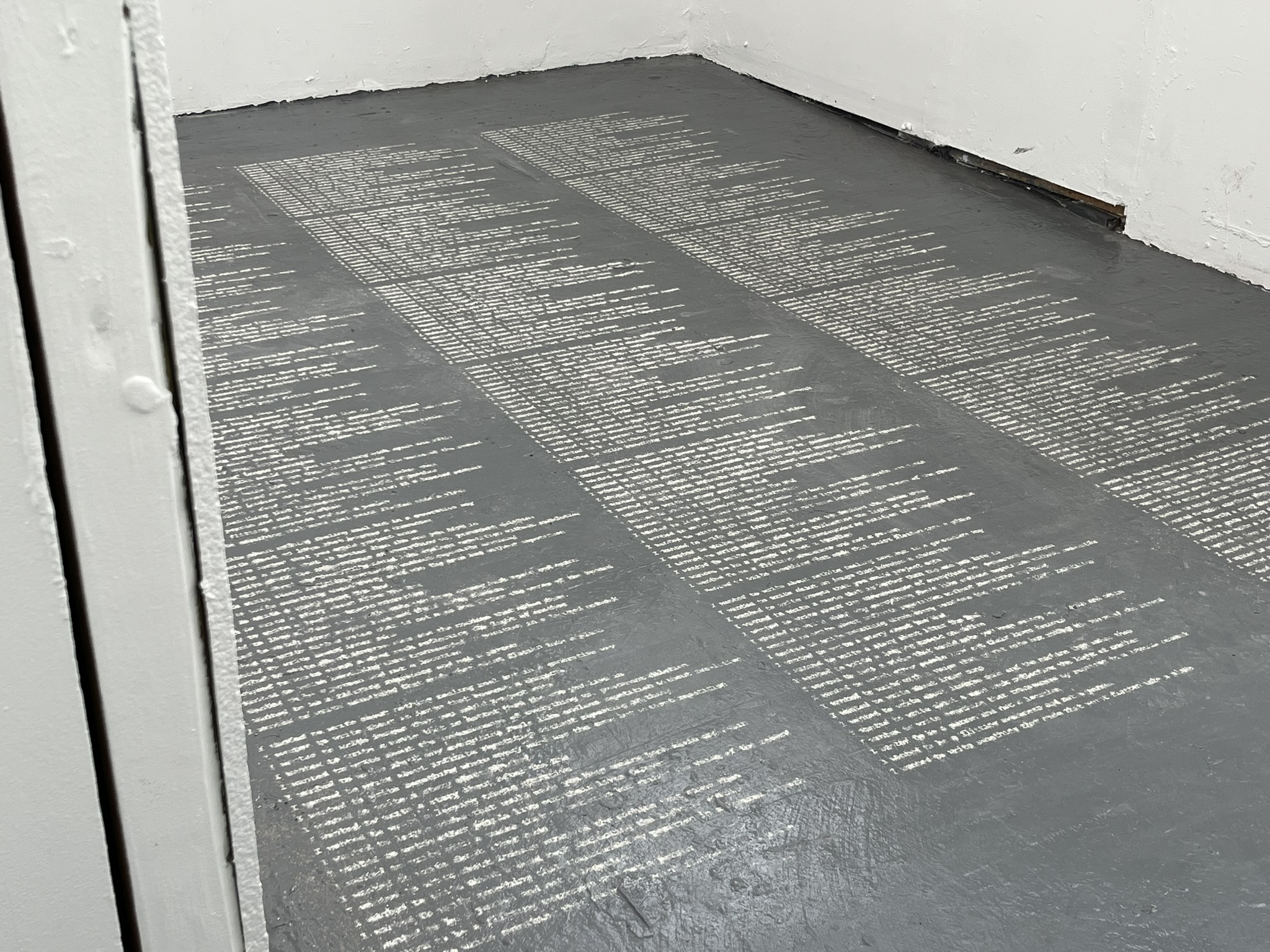 Three columns of text written in dust, taking up the room