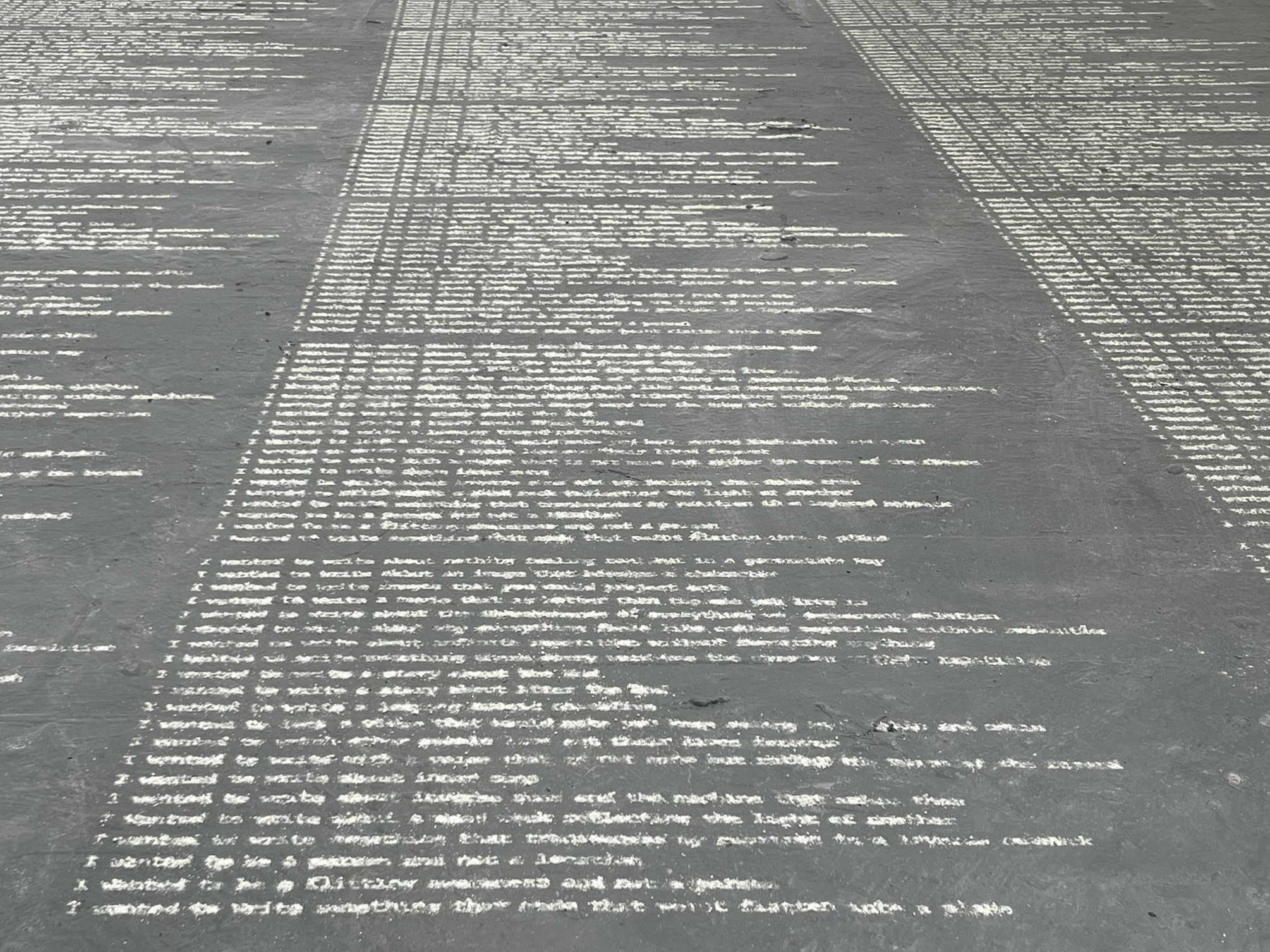 Three columns of text written in dust, taking up the room
