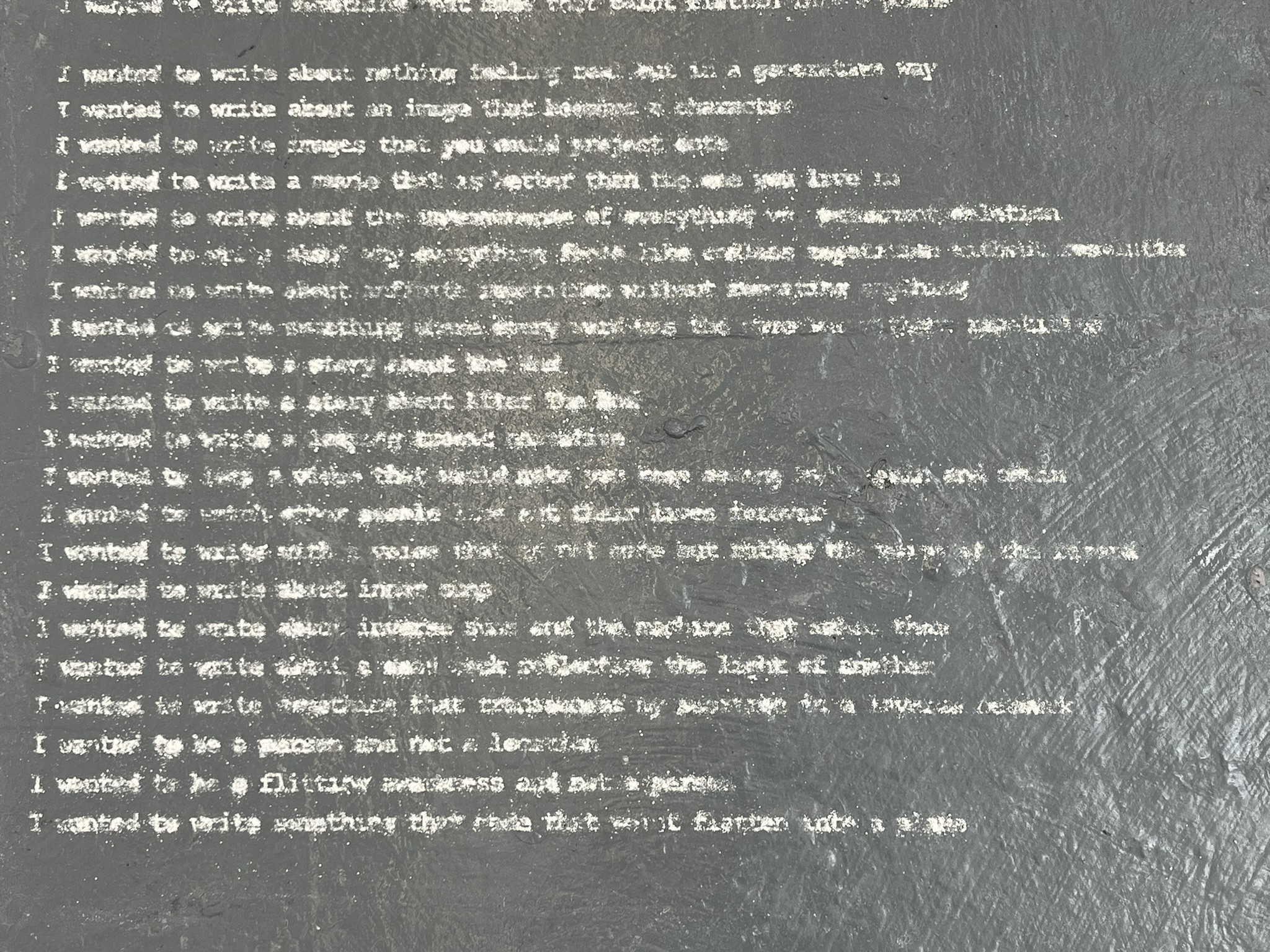 Three columns of text written in dust, taking up the room